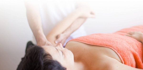 photo of woman being massaged