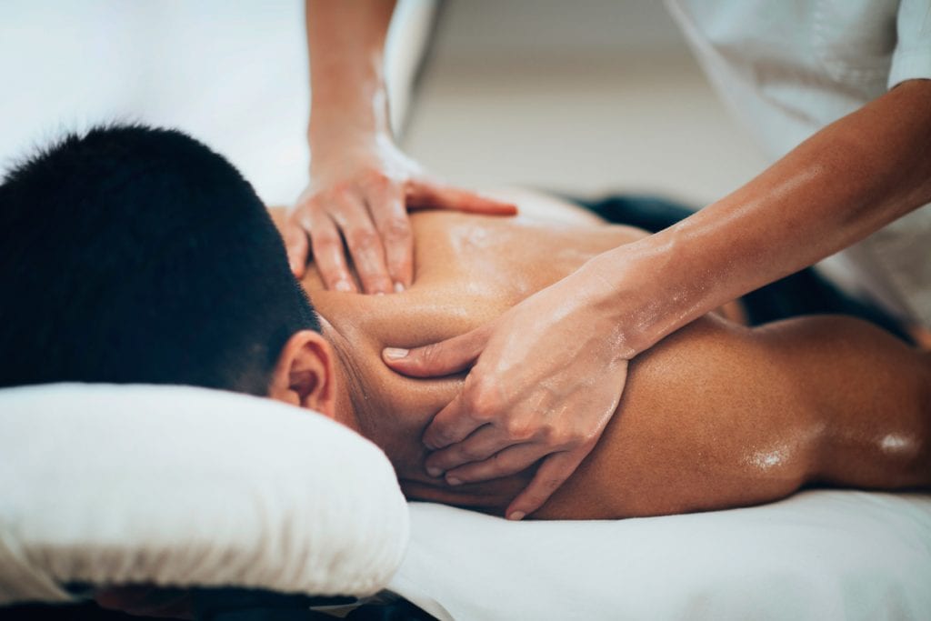 photo of a man receiving remedial massage therapy